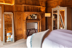 Bedroom with wood panelled walls