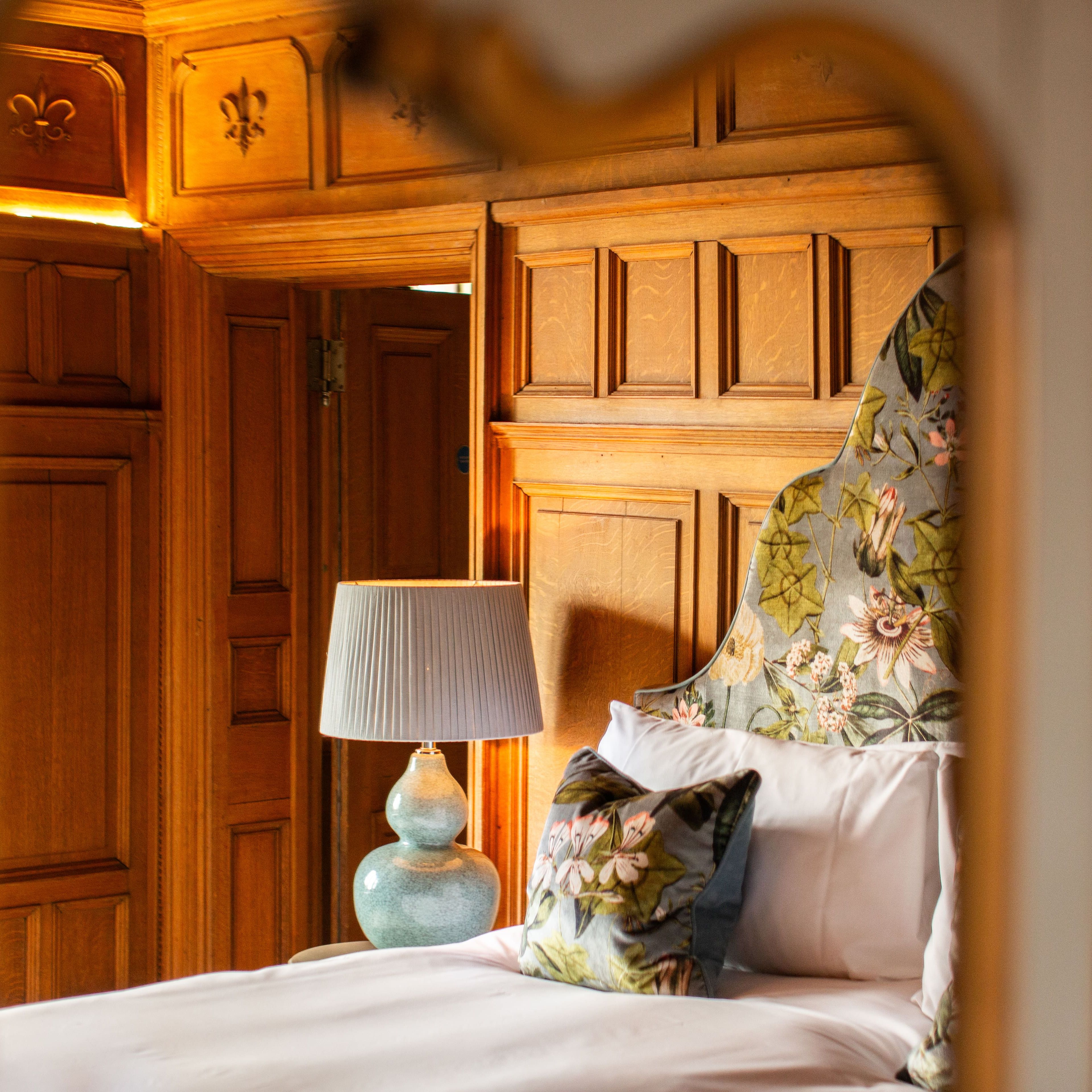 Bedroom with wood panelled walls