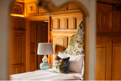 Bedroom with wood panelled walls
