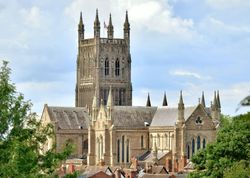 adam-joView of Worcester Cathedral towering above the city’s rooftops, framed by trees on a summer daynes-gKOAyHyxT2Q-unsplash
