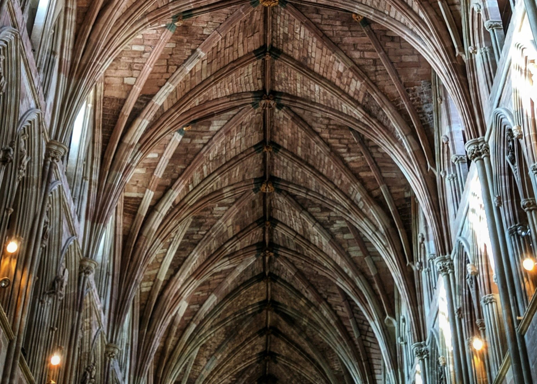Ornate vaulted ceiling inside Worcester Cathedral with stone arches and gothic detailing