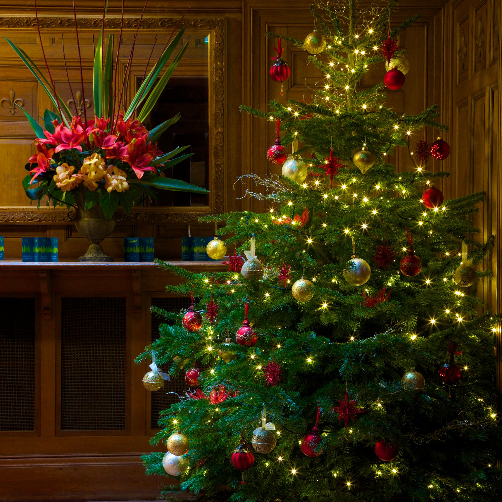 Christmas tree with lights and ornaments in a decorated room