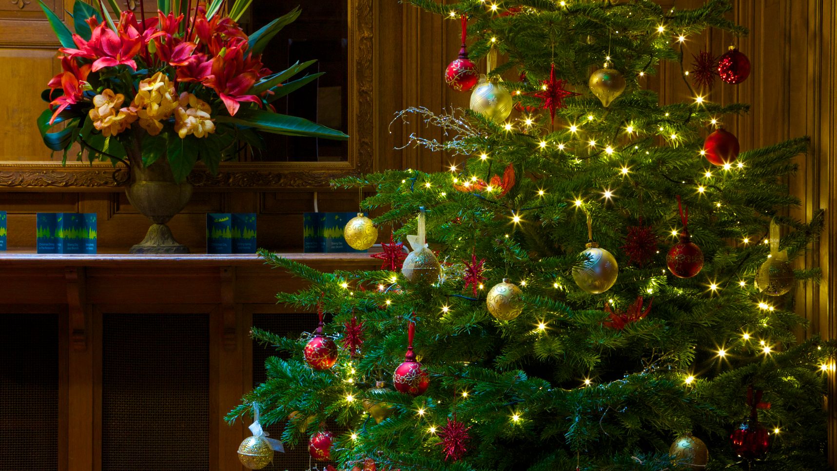 Christmas tree with lights and ornaments in a decorated room
