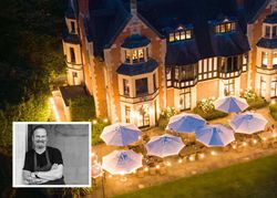 A nighttime aerial view of a grand building with outdoor seating and white umbrellas, inset with a black and white portrait of a smiling man with folded arms.