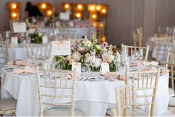 Elegant wedding reception table with floral centerpiece, place settings, and table number card
