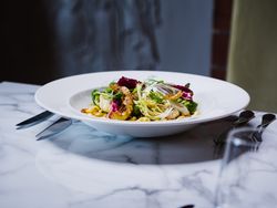 Bowl of pasta with cauliflower and a garden salad