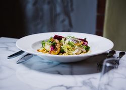 Bowl of pasta with cauliflower and a garden salad