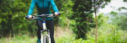 Person riding a mountain bike on a forest trail