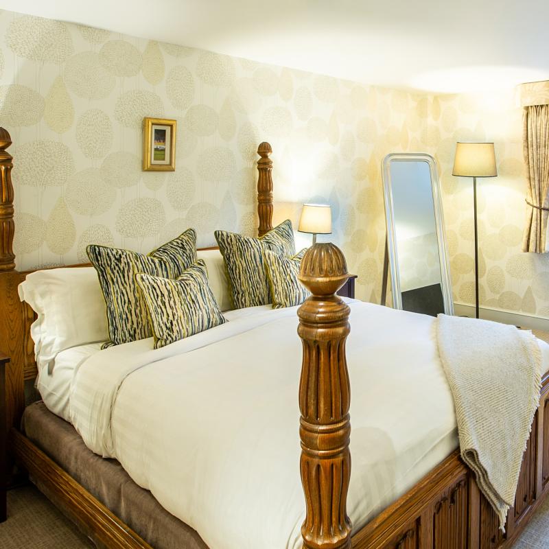 large bedroom with four poster half tester bed