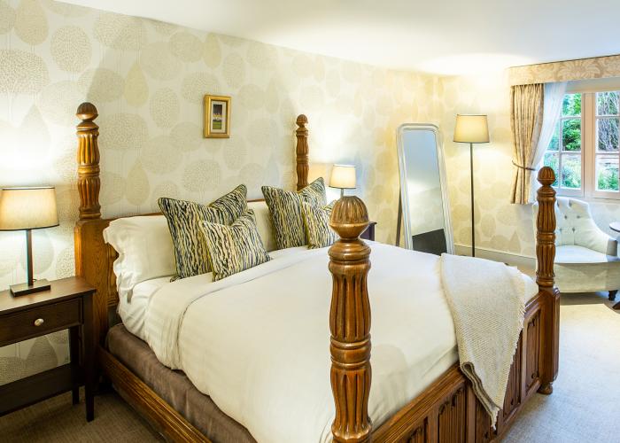large bedroom with four poster half tester bed