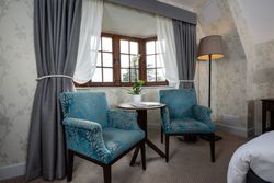 Two Armchairs in the window of a bedroom