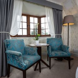 Two Armchairs in the window of a bedroom
