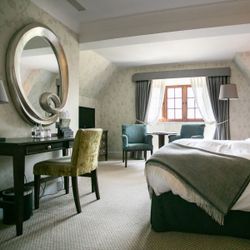 Large bedroom with big round mirror