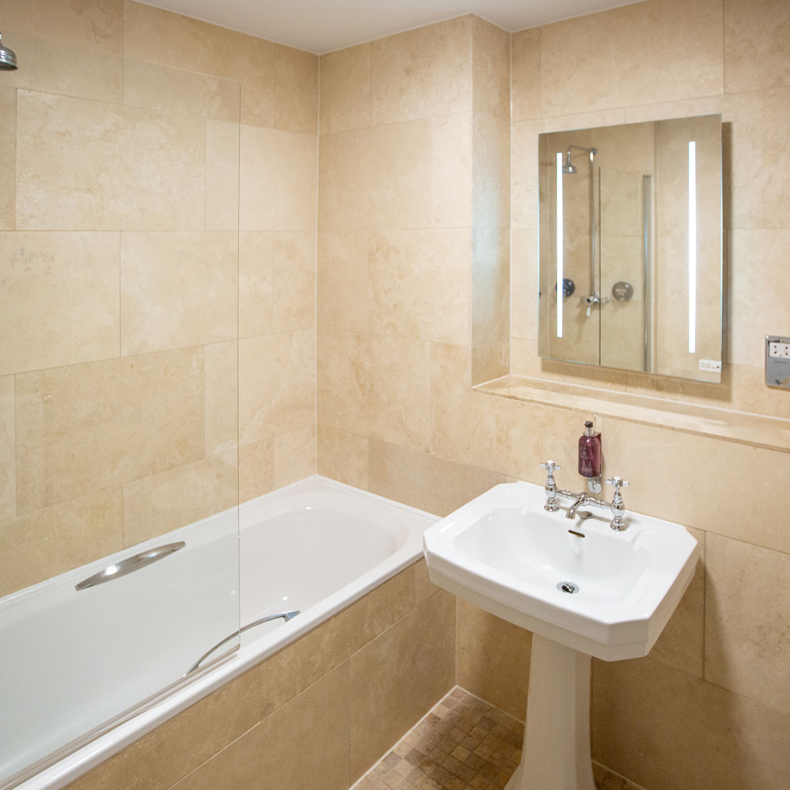 modern bathroom with shower over the bath