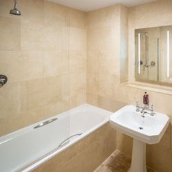 modern bathroom with shower over the bath